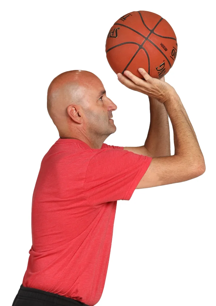 Ideal set point: shooting hand under the ball, with arrows showing the upward drive from the hand and elbow.